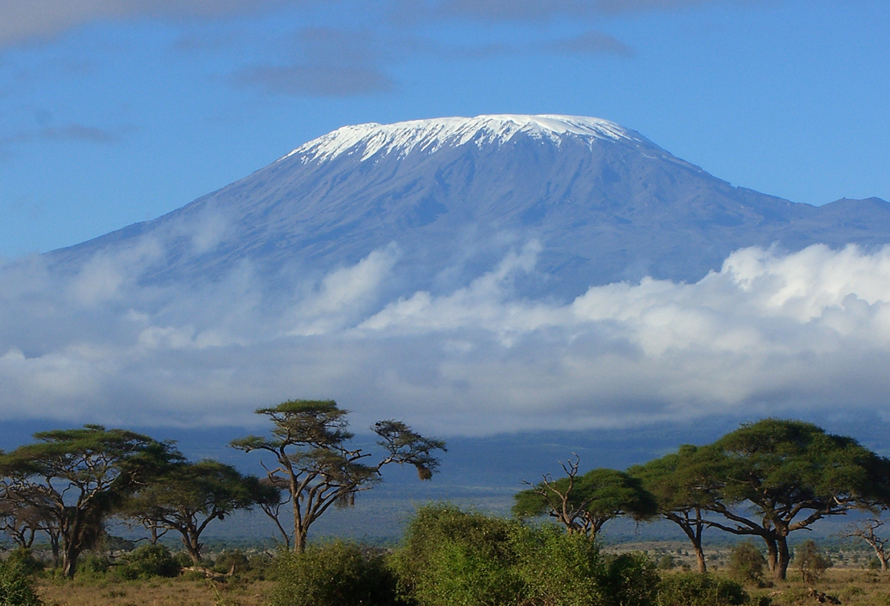 Snow-capped Mount Kilimanjaro rising above Tanzanian savanna at sunrise
